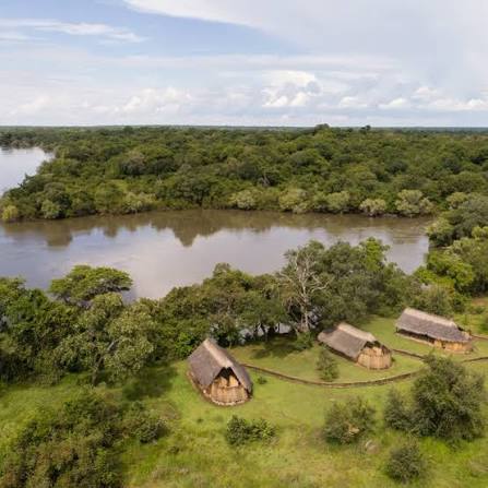 Thatched camp beside a river in Kafue National Park