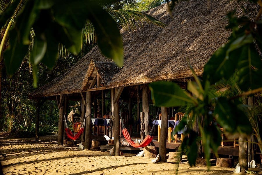 Thatched beach houses and hammocks at Masoala Forest Lodge