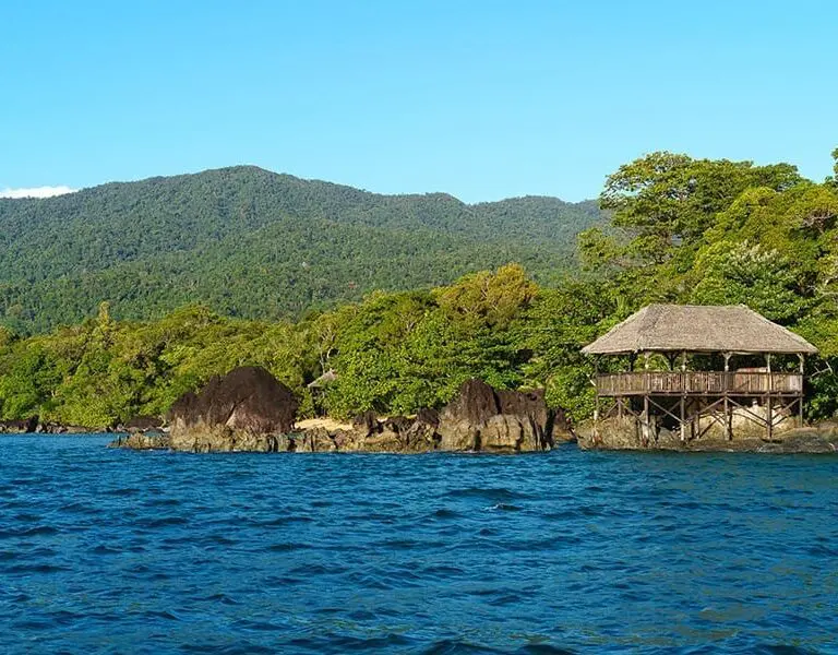 A thatched deck over the water, with the Masoala forest behind it