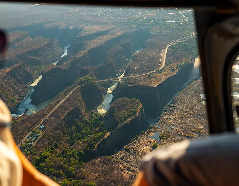 Sussi Chuma an AK Sanctuary Victoria Falls Zambia helicopter over falls